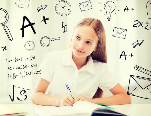 education and school concept - little student girl studying at school