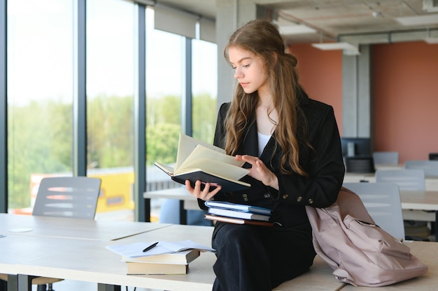 Photo education and school concept student girl studying and reading book at school