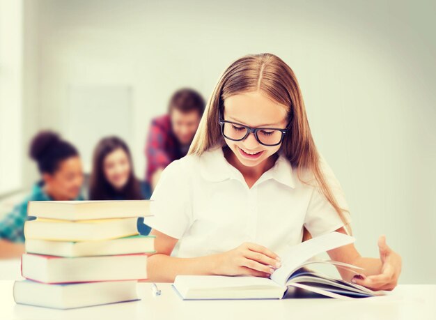 education and school concept - student girl studying and reading books at school