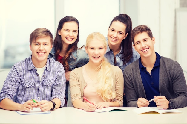 education, school and people concept - group of smiling students having fun at school