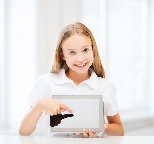 education, school, technology and internet concept - little student girl with tablet pc at school