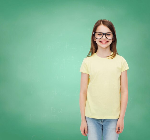 education, school and vision concept - smiling cute little girl in black eyeglasses