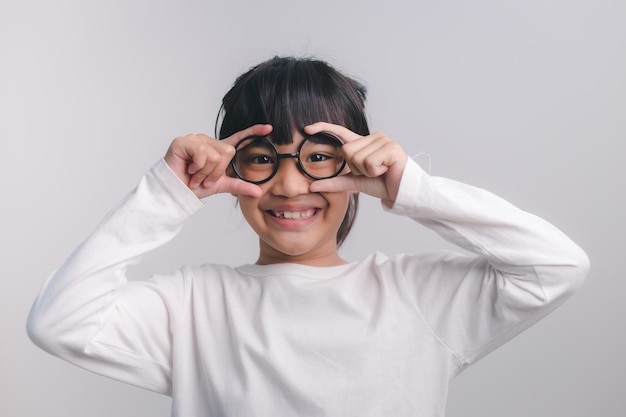 Education school and vision concept smiling cute little girl in black glasses