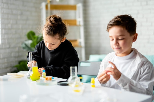 education science chemistry and children concept  kids doing experiment in school laboratory