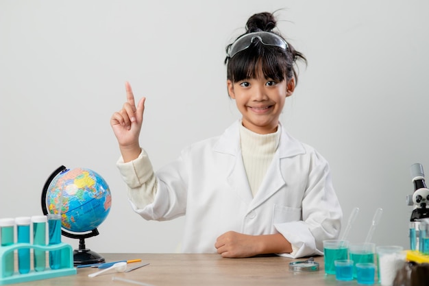 Education science chemistry and children concept kids or students with test tube making experiment at school laboratory