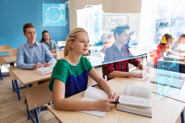 education, statistics and people concept - group of students with books at school lesson over virtual screens with charts