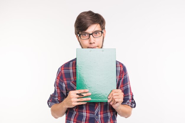 Education, student and business people concept - young man with file and pencil. guy is shy and confused