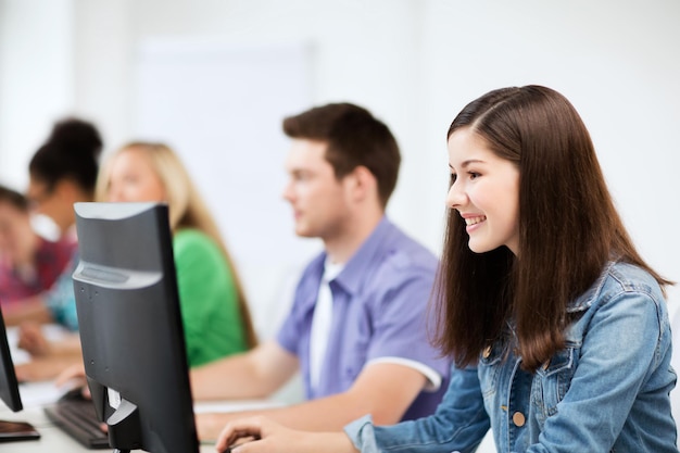 education, technology and internet - students with computers studying at school