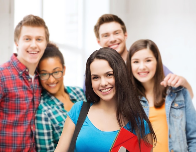 education, technology and people concept - smiling student with bag, folders and tablet pc computer standing