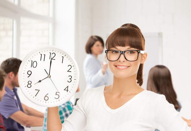 education and time management concept - attractive student showing clock