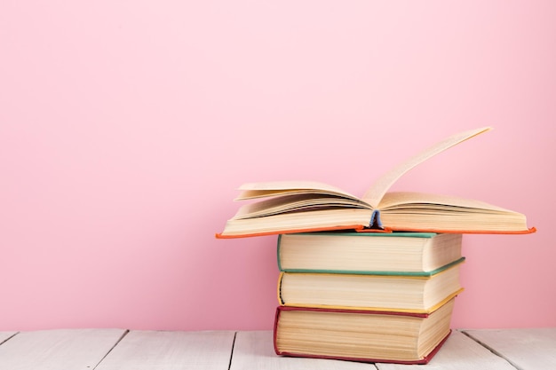 Education and wisdom concept open book on wooden table color background