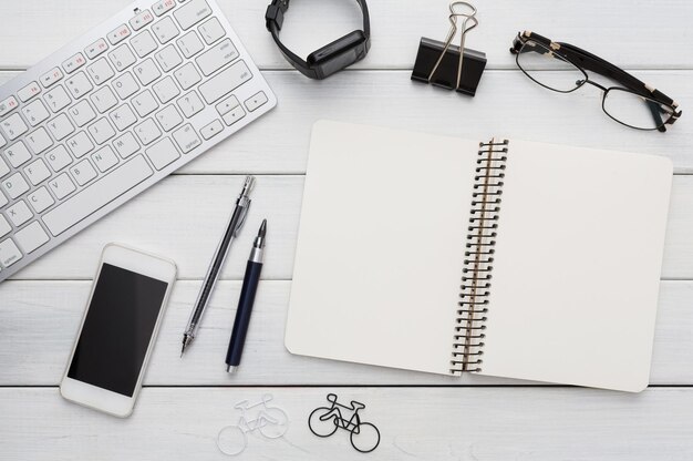 Education and work concept, top view shot of workplace. Stationery supplies, keyboard and mobile phone