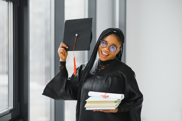 Educational theme: graduating student girl in an academic gown.