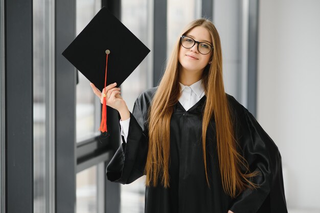 Educational theme: graduating student girl in an academic gown.