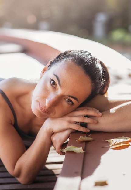 Een aantrekkelijke jonge vrouw met een trieste peinzende uitdrukking in een park op een zonnige dag Ondiepe scherptediepte vrouwelijk creatief portret