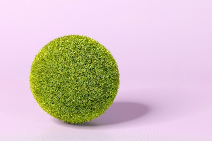 Een bal van groen gras op een paarse achtergrond zeer peri