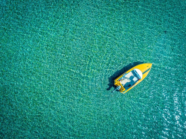 Een boot die op turkoois water vaart