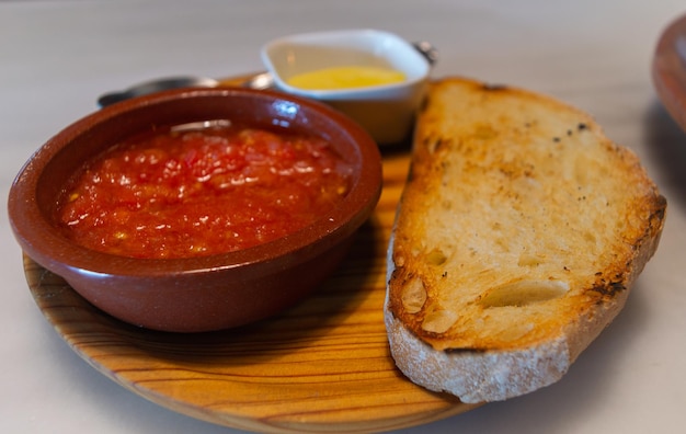 Foto een bord eten met een kom tomatensaus en een kom saus.