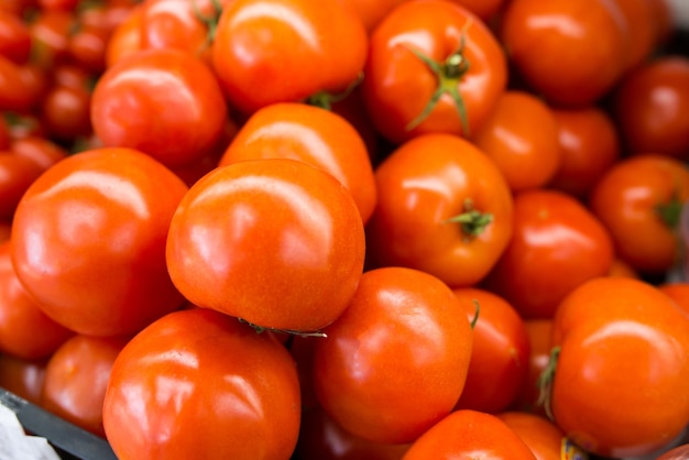 Een bosje verse rode tomaten bij de kruidenierswinkelopslag