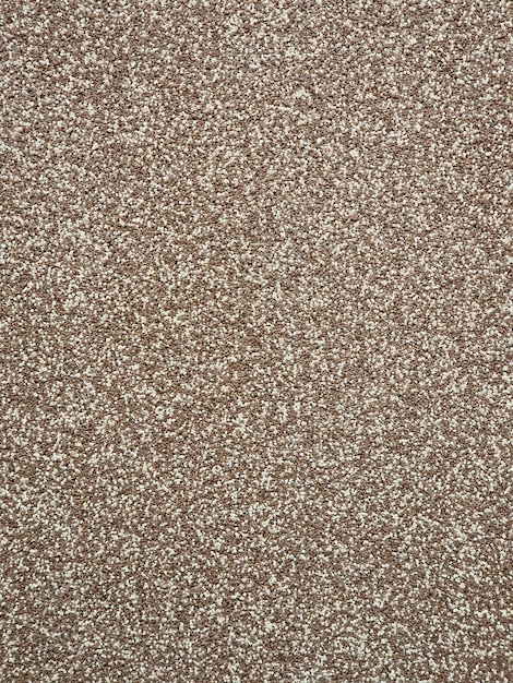 Een bruin tapijt met witte stippen en een bruine achtergrond