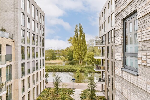 Foto een buitengebied met gebouwen en bomen op de voorgrond is van bovenaf genomen en kijkt naar de rivier