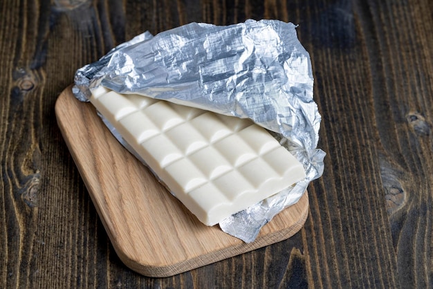 Foto een chocoladereep in een open verpakking van zilverfolie