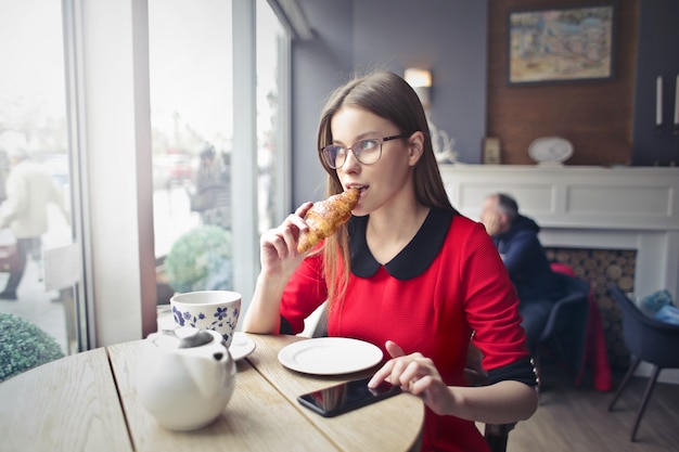 Een croissant in een koffiewinkel eten