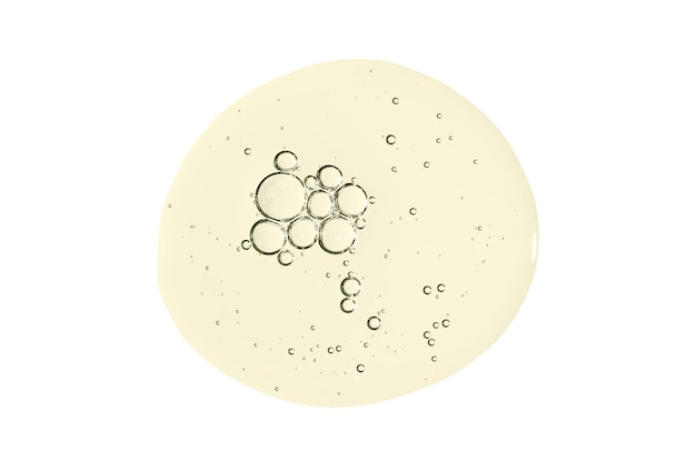 Een druppel lichaamsserum of cosmetische olie met bubbels vloeibaar huidverzorgingsproduct geïsoleerd op een witte achtergrond