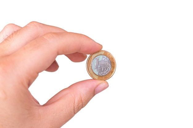 Een echte munt in de palm van iemands hand Hand met een munt van 1 dollar Echt is het valutasysteem van de Braziliaanse regering