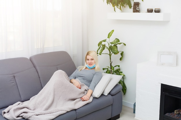 Een Europese vrouw heeft een virus en is verkouden en zit met een medisch masker op.