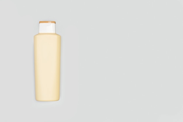 Een fles shampoo op grijs met exemplaarruimte