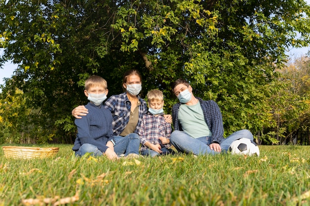 Een gezin met beschermende maskers in park