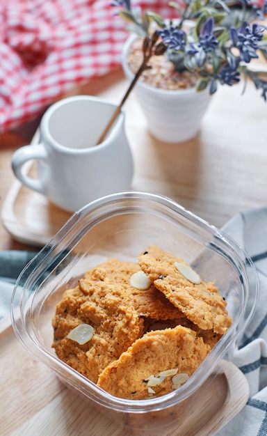 Een glazen bak met pompoenmuffins met een kopje koffie op de achtergrond.