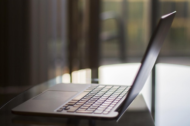 Een glazen tafel met een laptop