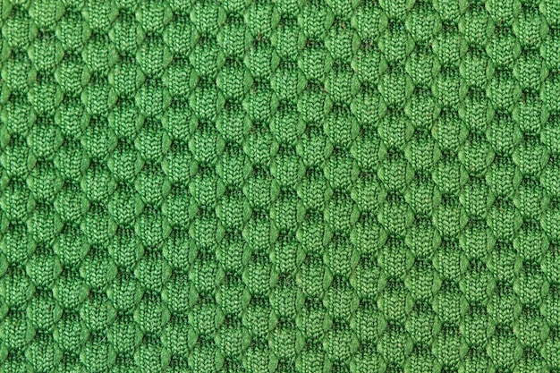 Een groene wollen doektextuur in een close-upweergave