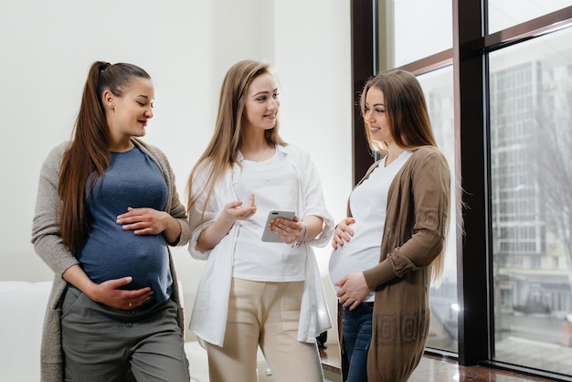 Een groep jonge zwangere meisjes communiceert in de prenatale klas. Verzorging en consultatie van zwangere vrouwen
