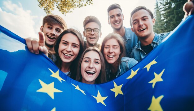 een groep jongeren maakt een selfie, op de achtergrond wappert de vlag van de europese unie