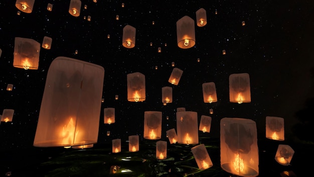 Een groep prachtige luchtlantaarns in de donkere lucht 's nachts chinese vliegende lantaarn memorial day