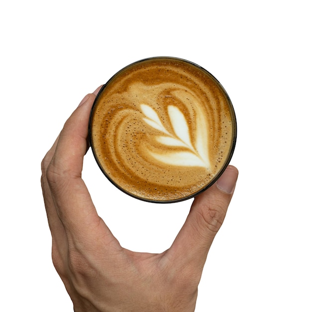 Een hand met een kopje koffie met een latte art erop.