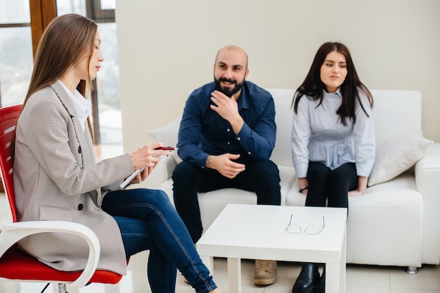 Een jong getrouwd stel van mannen en vrouwen praat tijdens een therapiesessie met een psycholoog. Psychologie.