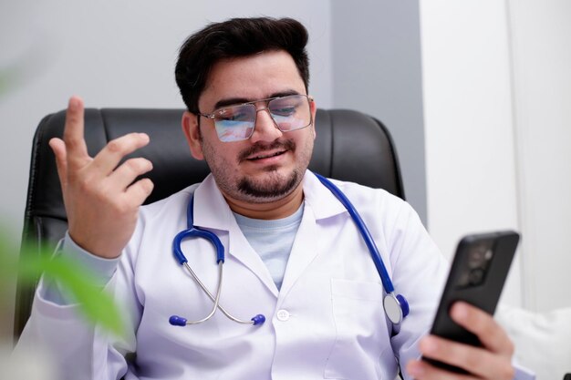 Foto een jonge dokter zit in de kliniek en praat via een videogesprek