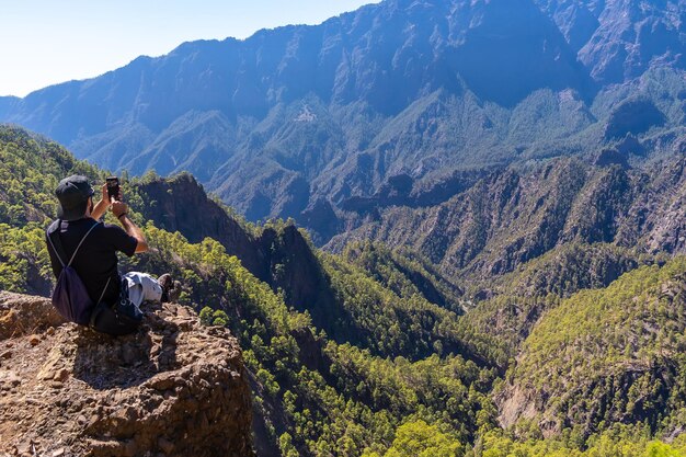 Een jonge man die uitrust na een trektocht op de top van La Cumbrecita, zittend in de natuur