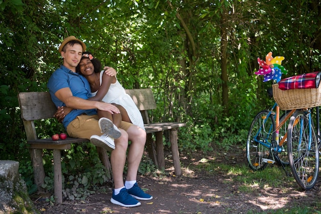 een jonge man en een mooi Afro-Amerikaans meisje genieten van een fietstocht in de natuur op een zonnige zomerdag