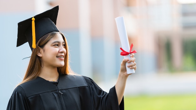 Een jonge universitair afgestudeerde is in het bezit van een diploma