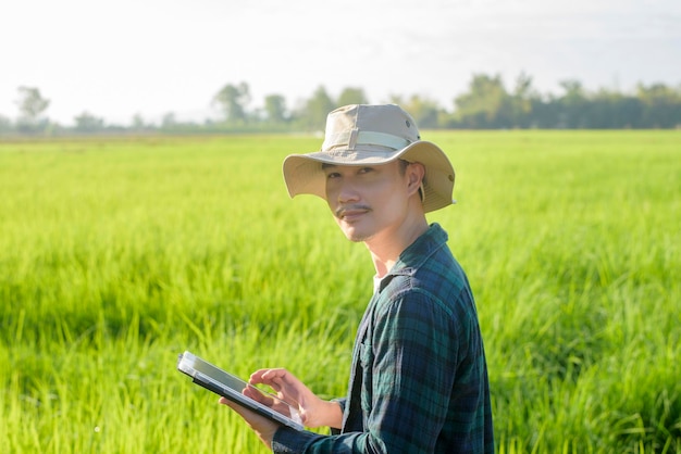 Een jonge vrouwelijke slimme boer met tablet op het veld, hoogtechnologische innovaties en slimme landbouw
