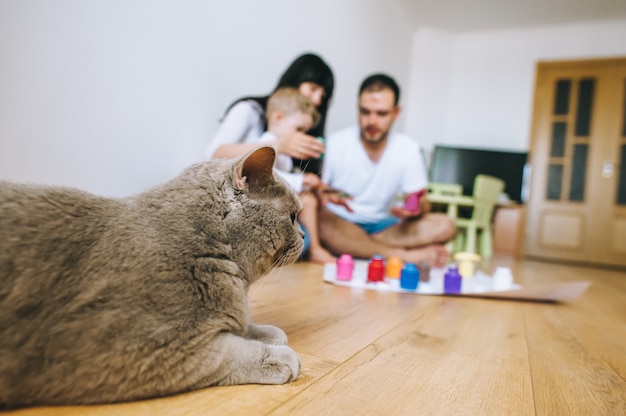 Foto een kat met een gezin schildert papier in de kamer