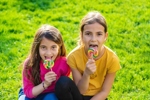 Een kind eet een lolly in het park Selectieve aandacht