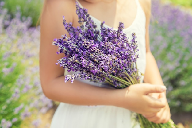 Een kind in een bloeiend veld met lavendel.