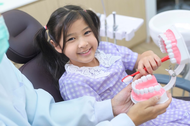 Een klein schattig meisje met tanden onderzocht door tandarts in tandheelkundige kliniek tanden