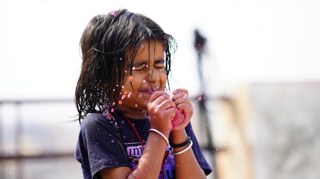 Een klein schattig meisje speelt met water afbeelding